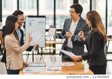 Business team clapping and celebrating success during meeting in modern office. 117600005