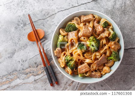 Beef teriyaki, noodles, mushrooms and broccoli stir fry close-up in a bowl. Horizontal top view Beef teriyaki, noodles, mushrooms and broccoli stir fry close-up in a bowl. Horizontal top view 117601308