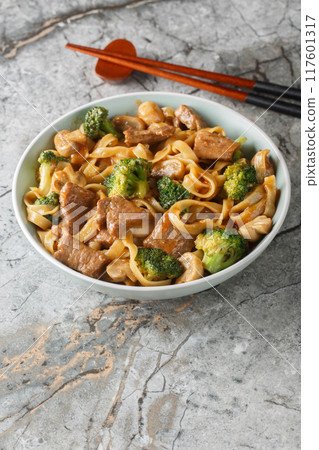 Homemade Beef Noodles with mushrooms and Broccoli closeup on the bowl. Vertical Homemade Beef Noodles with mushrooms and Broccoli closeup on the bowl. Vertical 117601317