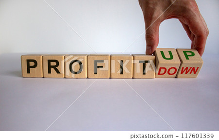 Hand turns cubes and changes the expression 'profit down' to 'profit up'. Beautiful white background. Business concept, copy space. Hand turns cubes and changes the expression 'profit down' to 'profit up'. Beautiful white background. Business concept, copy space. 117601339