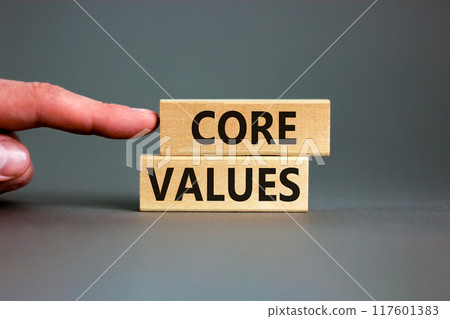 Core values symbol. Concept words Core values on wooden blocks on a beautiful grey table grey background. Businessman hand. Business value and core values concept, copy space. Core values symbol. Concept words Core values on wooden blocks on a beautiful grey table grey background. Businessman hand. Business value and core values concept, copy space. 117601383