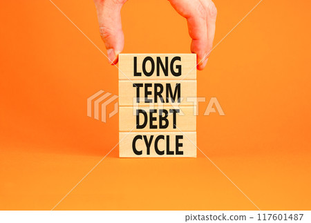 Long term debt cycle symbol. Concept words Long term debt cycle on beautiful wooden block. Beautiful orange table orange background. Businessman hand. Business Long term debt cycle concept. Copy space Long term debt cycle symbol. Concept words Long term debt cycle on beautiful wooden block. Beautiful orange table orange background. Businessman hand. Business Long term debt cycle concept. Copy space 117601487