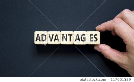 Advantages symbol. Concept word Advantages on beautiful wooden cubes. Beautiful black background. Businessman hand. Business advantages concept. Copy space. 117601529