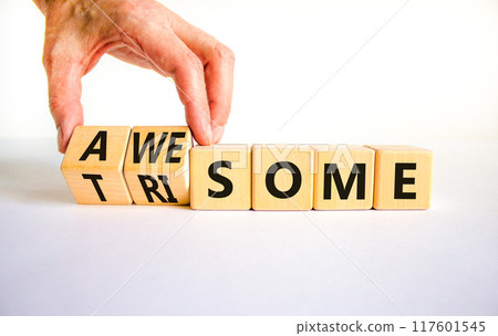 Awesome or trisome symbol. Doctor turns wooden cubes and changes the concept word awesome to trisome. Beautiful white table, white background, copy space. Medical, awesome or trisome concept. 117601545