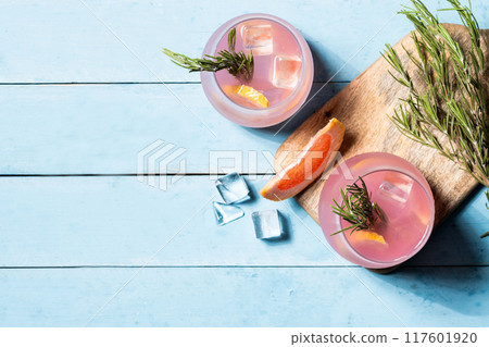 Grapefruit cocktail on blue wooden table. Top view. Copy space 117601920