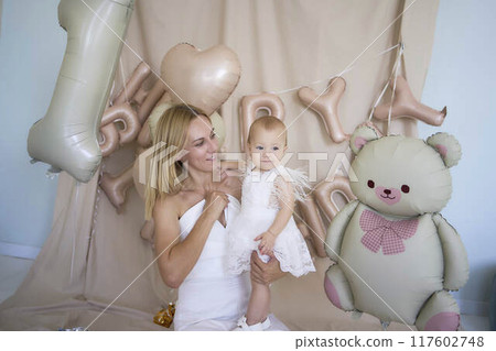 photo session on the first birthday of a baby girl with her mother, in pastel colors, minimalism 117602748