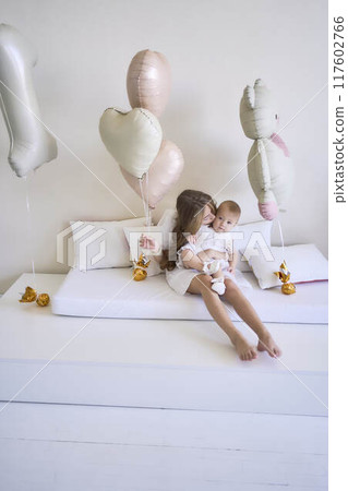a photo session on the first birthday of a baby girl with her teenage sister, in pastel colors, minimalism a photo session on the first birthday of a baby girl with her teenage sister, in pastel colors, minimalism 117602766