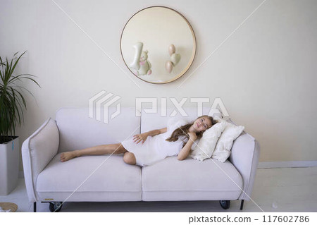 beautiful pre-teen girl in white clothes in a stylish minimalist interior beautiful pre-teen girl in white clothes in a stylish minimalist interior 117602786