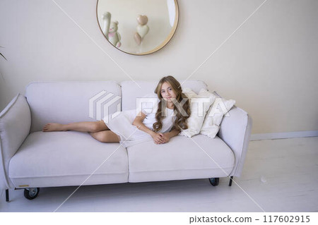 beautiful pre-teen girl in white clothes in a stylish minimalist interior beautiful pre-teen girl in white clothes in a stylish minimalist interior 117602915