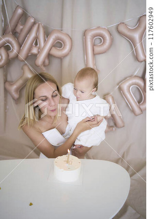 baby girl tries her first birthday cake with mom and pre-teen sister baby girl tries her first birthday cake with mom and pre-teen sister 117602949
