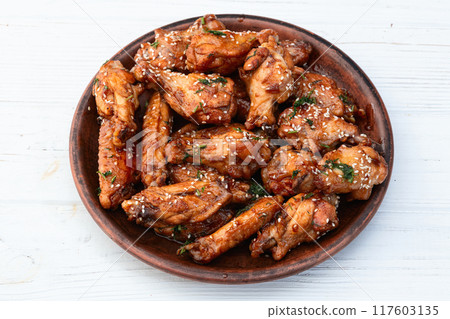 Caramelized in sause chicken wings . Bar-b-q food background photo Caramelized in sause chicken wings . Bar-b-q food background photo 117603135