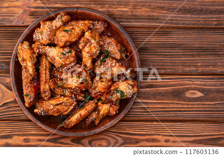 Caramelized in sause chicken wings . Bar-b-q food background photo Caramelized in sause chicken wings . Bar-b-q food background photo 117603136