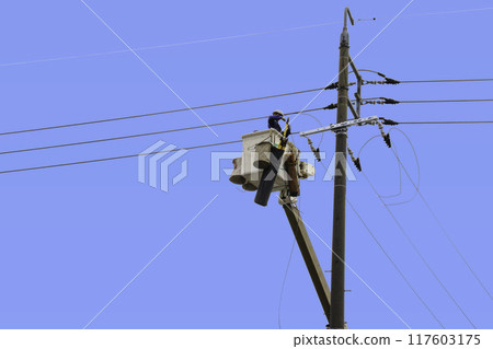 A person working at height with the sky in the background 117603175