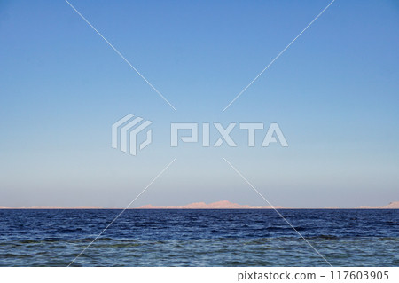 Red sea in Egypt and Tiran island (Saudi Arabia) arid mountains in the distance 117603905