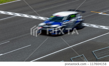 Motion blur race car racing on speed track, Car race on the international circuit race track crossing start and finish line, Race car crossing start and finish line, Target business achieve victory. Motion blur race car racing on speed track, Car race on the international circuit race track crossing start and finish line, Race car crossing start and finish line, Target business achieve victory. 117604158