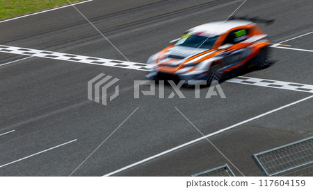 Motion blur race car racing on speed track, Car race on the international circuit race track crossing start and finish line, Race car crossing start and finish line, Target business achieve victory. Motion blur race car racing on speed track, Car race on the international circuit race track crossing start and finish line, Race car crossing start and finish line, Target business achieve victory. 117604159
