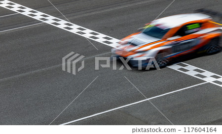 Motion blur race car racing on speed track, Car race on the international circuit race track crossing start and finish line, Race car crossing start and finish line, Target business achieve victory. 117604164