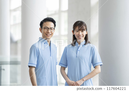 Image of a facility staff member in his 30s looking at the camera wearing a blue polo shirt 117604221