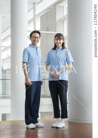 Image of a facility staff member in his 30s looking at the camera wearing a blue polo shirt 117604249