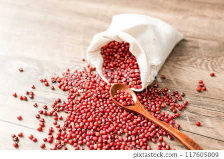 Red beans in cloth bag on wooden board 117605009