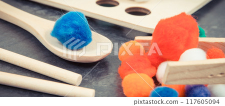 Colorful pompoms as accessories using for playing and development of kids motor skills 117605094
