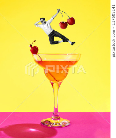 Poster. Contemporary art collage. Man in retro attire holding cherries jumps into tropical, sweet cocktail against pink yellow background 117605141