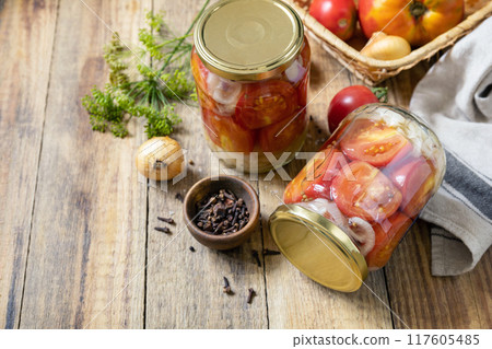 Healthy homemade fermented food. Salted pickled tomatoes and onions preserved canned in glass jar. Home economics, autumn harvest preservation. Copy space. 117605485