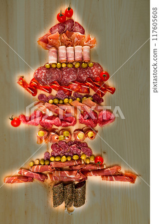 Christmas tree made of sausage on a background of a wooden wall Christmas tree made of sausage on a background of a wooden wall 117605608
