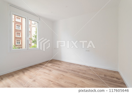 Imagine a bright, modernstyle empty room with wooden flooring and large windows 117605646