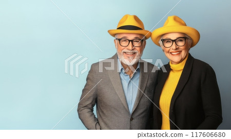 Happy senior couple wearing matching yellow hats and glasses 117606680