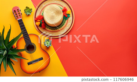 Hispanic Heritage month background. A traditional Mexican sombrero hat and a flamenco guitar on vibrant plain orange and yellow background, top view. AI generated. 117606946