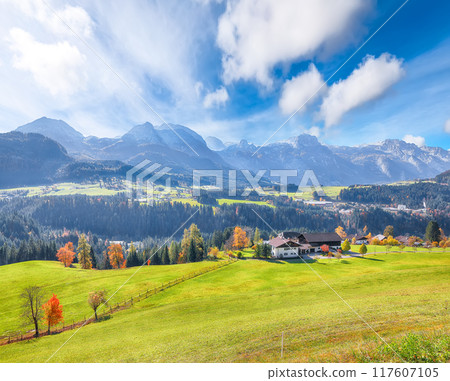 Breathtaking view of  Alpine green fields and traditional wooden houses near Abtenau village at autumn sunny day. 117607105