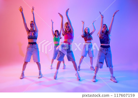 Fluid motions and powerful expressions make this dance in neon light against gradient pink background. Teenagers performing. 117607159