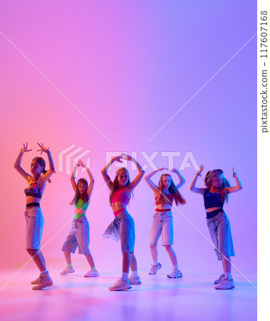 Poster. Group of artistic young girls dressed casual, sport attire moves in synch in neon light against gradient pink background. Poster. Group of artistic young girls dressed casual, sport attire moves in synch in neon light against gradient pink background. 117607168
