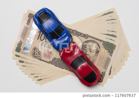A miniature car involved in a collision and the new 100,000 yen banknote A miniature car involved in a collision and the new 100,000 yen banknote 117607637