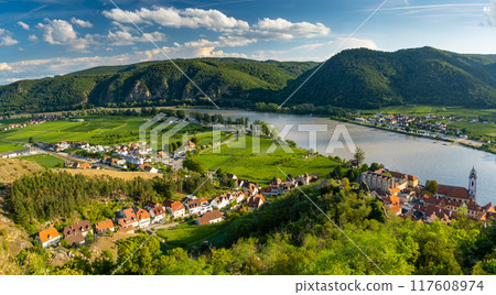 Panorama of Wachau valley with Danube river near Duernstein village in Lower Austria. Traditional wine and tourism region, Danube cruises. Panorama of Wachau valley with Danube river near Duernstein village in Lower Austria. Traditional wine and tourism region, Danube cruises. 117608974