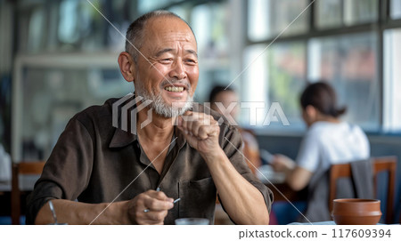 Elderly Man Enjoying Tea at a Bustling Daytime Cafe Elderly Man Enjoying Tea at a Bustling Daytime Cafe 117609394
