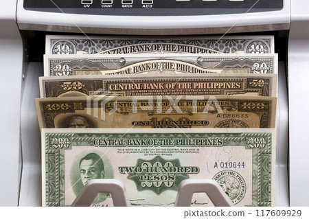 Old Philippine peso in the counting machine 117609929