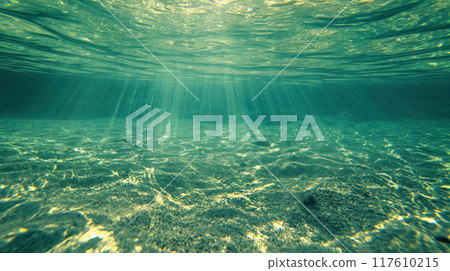 Sunbeams penetrating clear underwater scene. 117610215