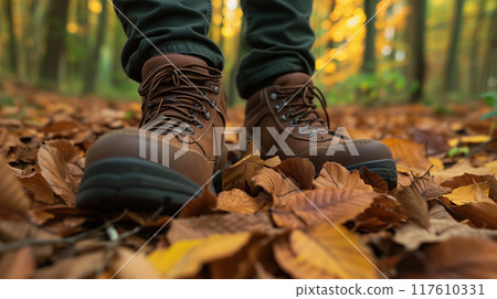 Hiking boots on a bed of autumn leaves. 117610331
