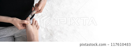 Cut long nails on male foot.  Making pedicure procedure 117610483