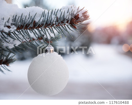 New year ball on snowy pine tree branch with snow. Christmas decoration. Winter holidays New year ball on snowy pine tree branch with snow. Christmas decoration. Winter holidays 117610488