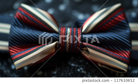 Striped bow tie on a glittery surface. Striped bow tie on a glittery surface. 117610652