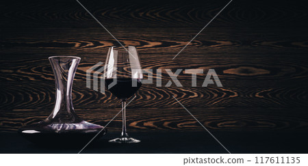 Decanter and glass with red wine on wooden rustic background 117611135