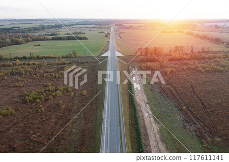 Railway and asphalt road through autumn forest. Aerial view 117611141