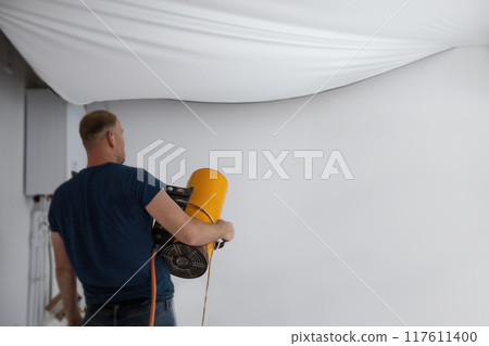 Installs a stretch ceiling Installs a stretch ceiling 117611400
