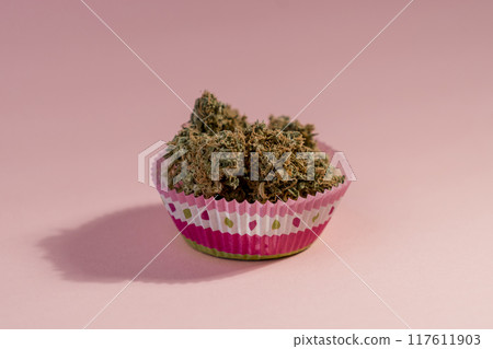 Cake with medical marijuana buds on pink background, close up. 117611903