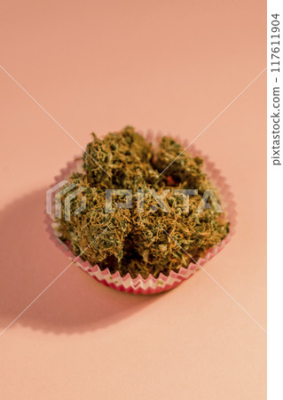 Cake with medical marijuana buds on pink background, close up. 117611904