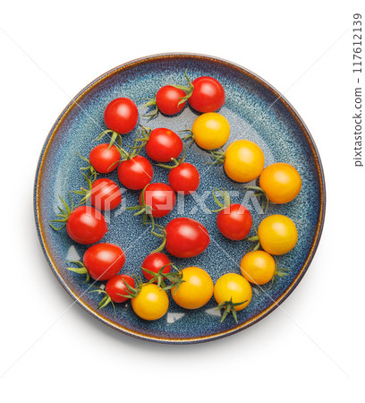 Different colorful cherry tomatoes on plate isolated on white background. Different colorful cherry tomatoes on plate isolated on white background. 117612139