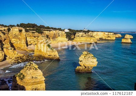 Praia da Marinha Beach among rock islets and cliffs seen from Seven Hanging Valleys Trail, Algarve, Portugal 117612187
